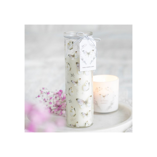 Decorative candle with butterfly design on a white background