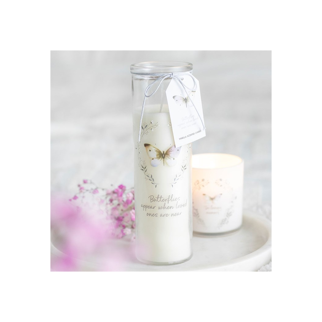 Candle in a glass jar with a butterfly design and tag, on a white background
