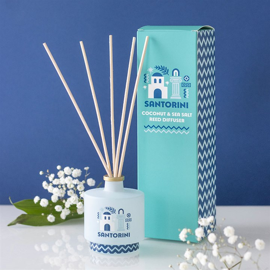 Santorini coconut & sea salt reed diffuser with packaging against a blue background