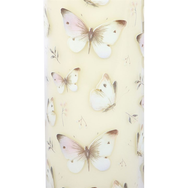 Butterfly-patterned tube candle on a light yellow background