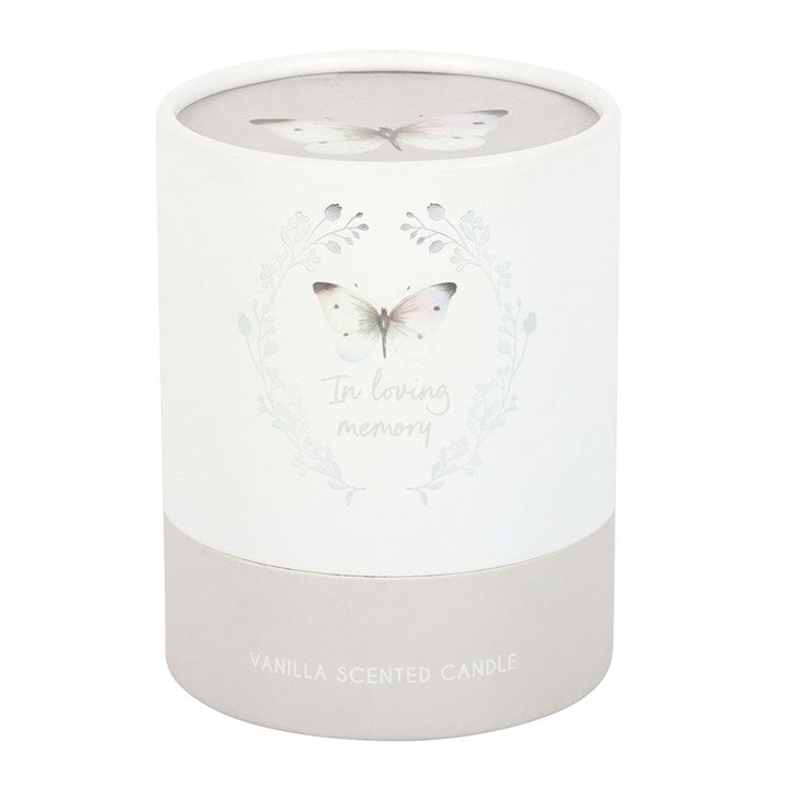 White candle with butterfly design and 'In loving memory' text on a white background
