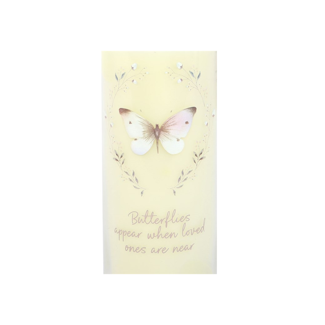 Tube candle with a butterfly design and text on a light yellow background