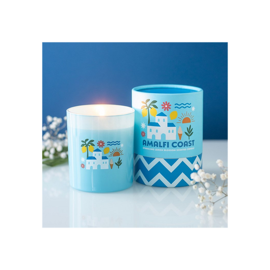 Two blue candles with 'Amalfi Coast' design on a white surface with a blue background