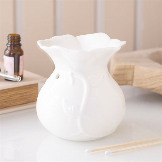 White ceramic diffuser on a white surface with a blurred background